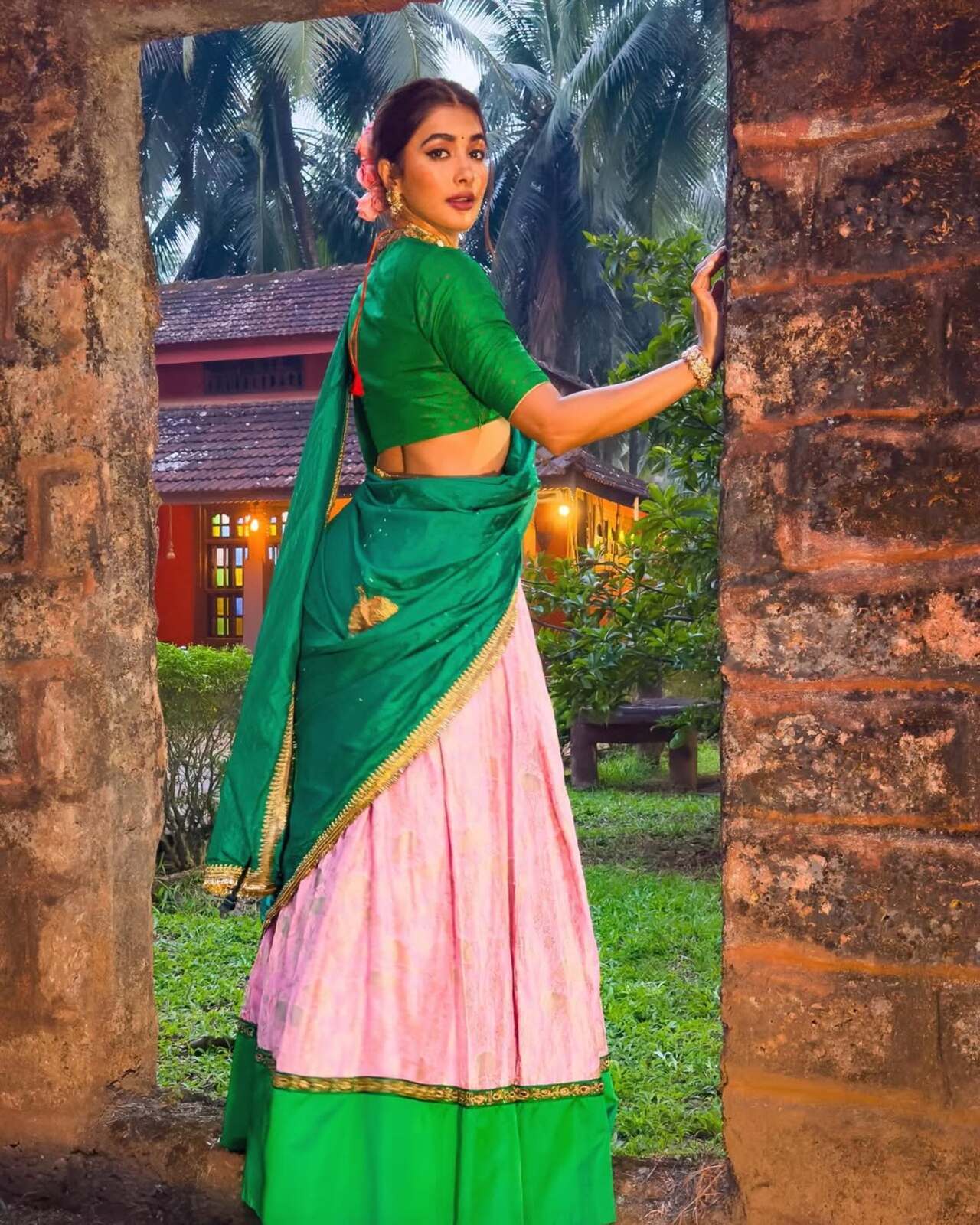 The davani or the half-saree is a common favourite among the young ladies in the south. Pooja beautifully paired a pink and green combination half saree for a shoot